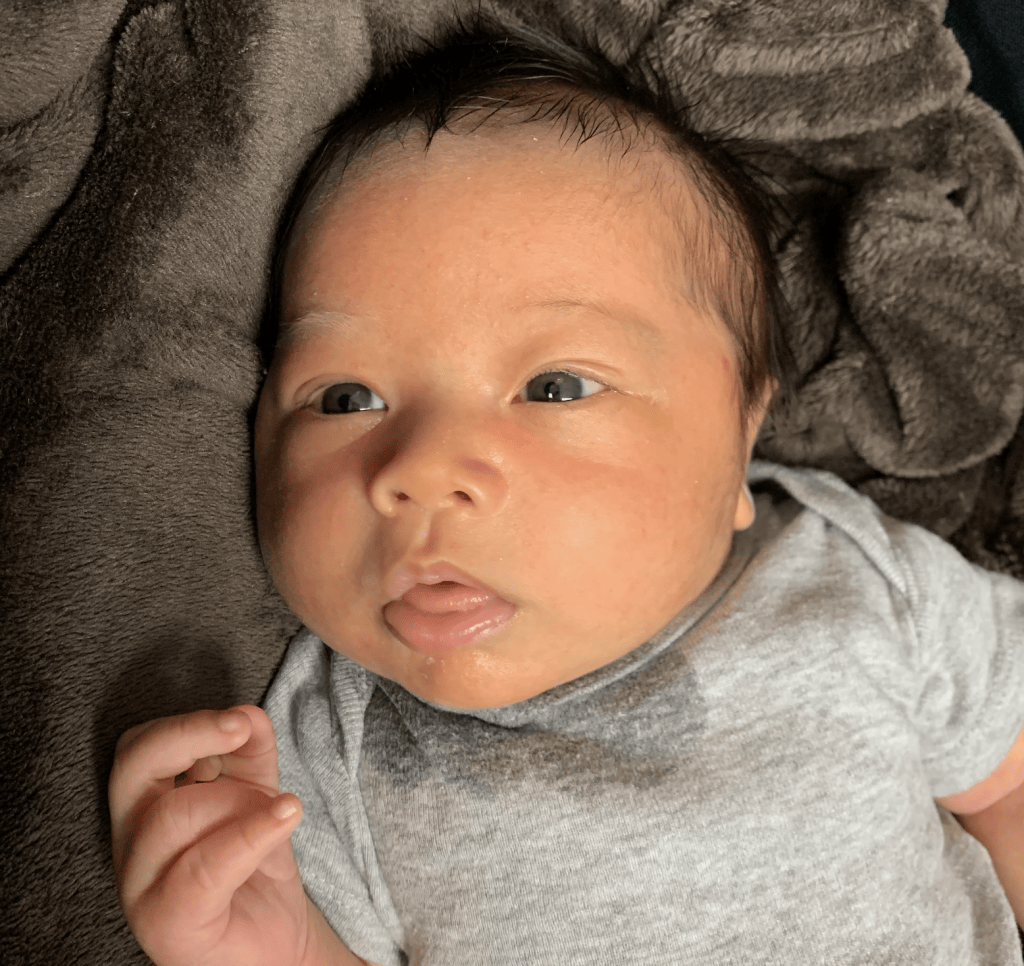 Close-up portrait of a newborn lying on a blanket