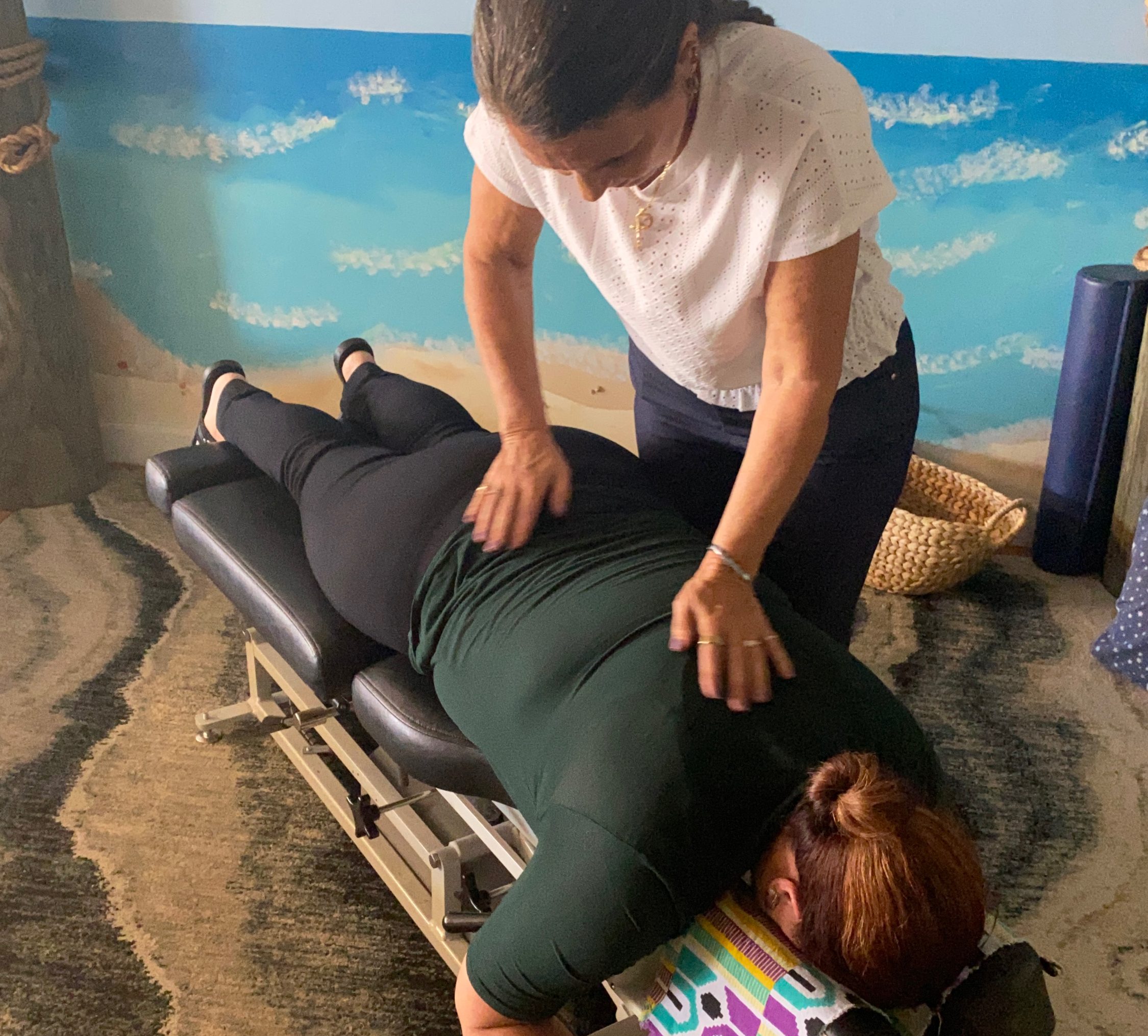 Dr. Karolyn performing a prone adjustment on a patient