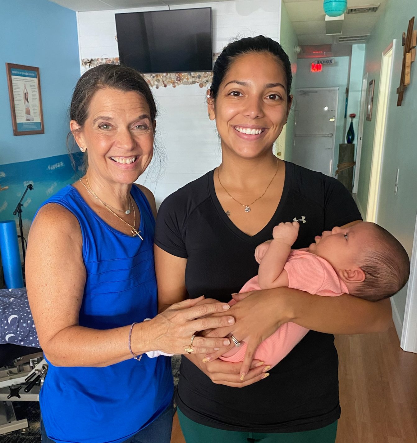 Dr. Karolyn standing with a mother holding her baby