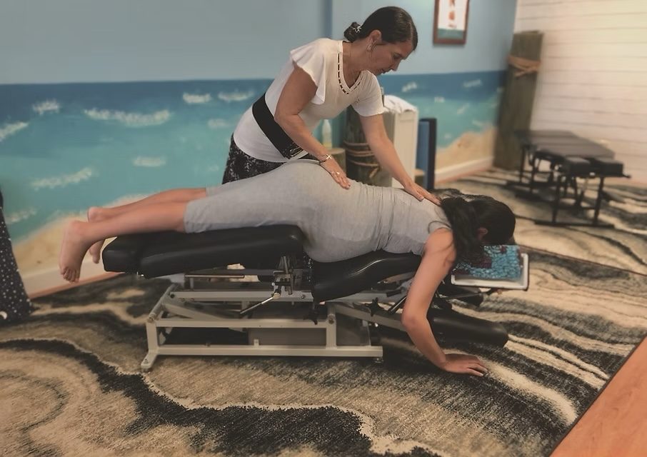Dr. Karolyn adjusting a pregnant patient on a chiropractic table