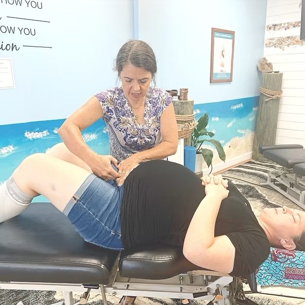 Dr. Karolyn adjusting a pregnant patient lying on her side