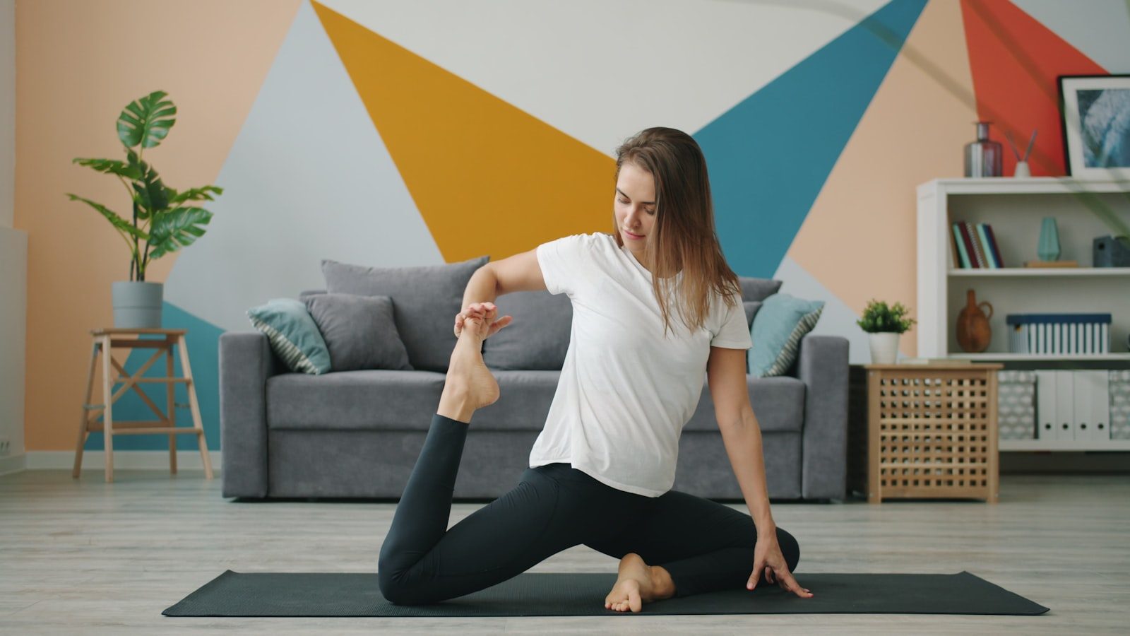 Woman practicing yoga in a living room
