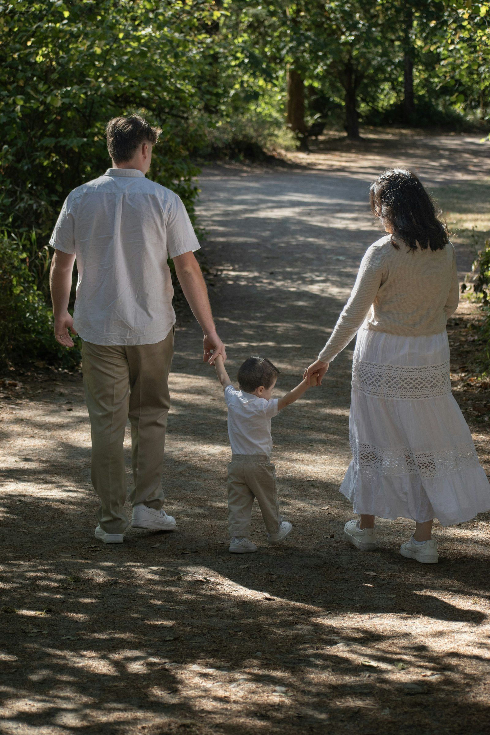 Family walking together on a wooded path