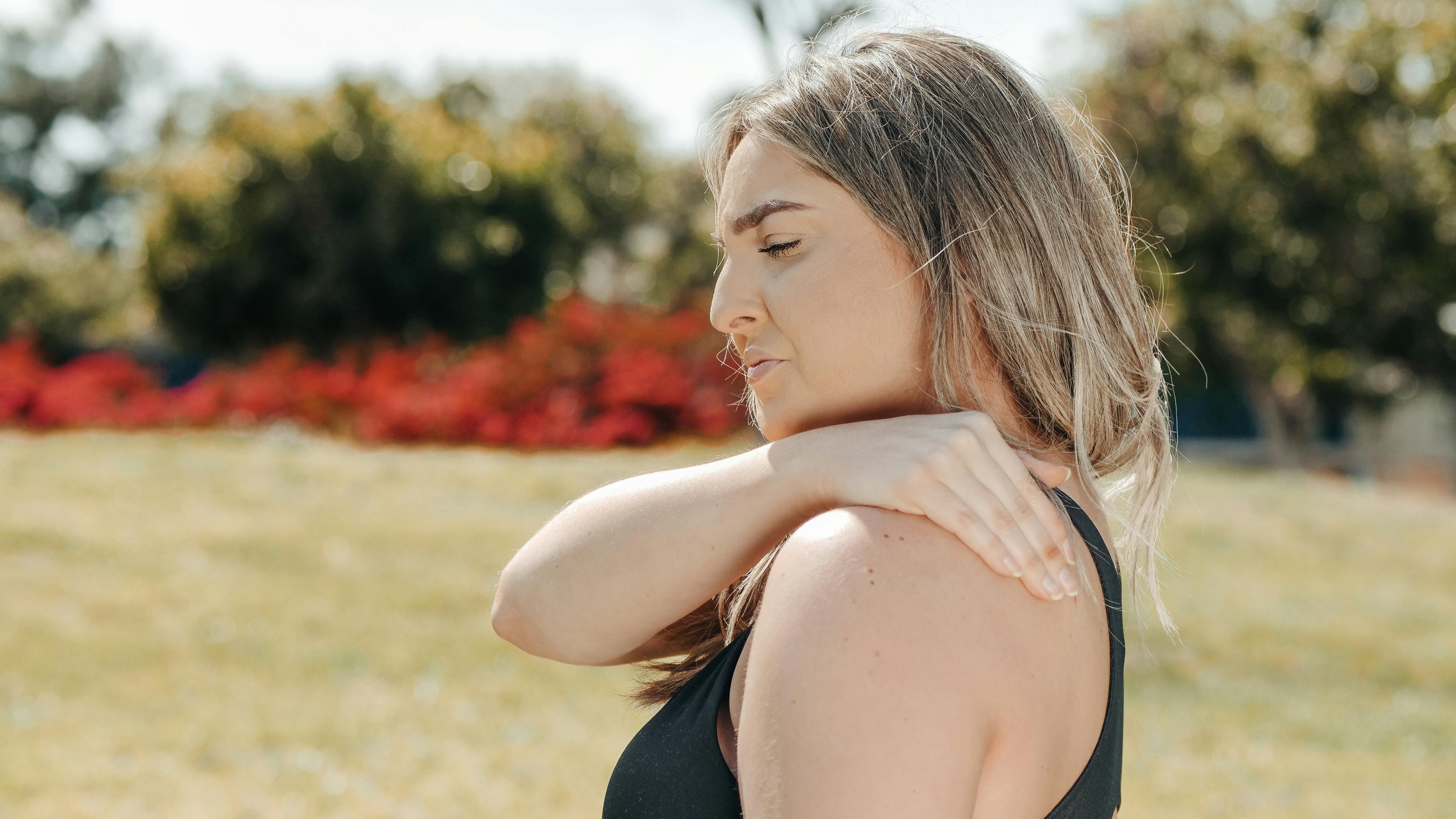 Woman touching shoulder